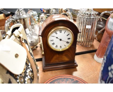 A mahogany cased mantle clock having French movement and enamel face dial