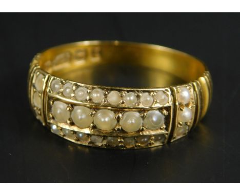 A 15ct gold seed pearl dress ring, set with central row of five seed pearls, surrounded by two further rows of eight pearls, 