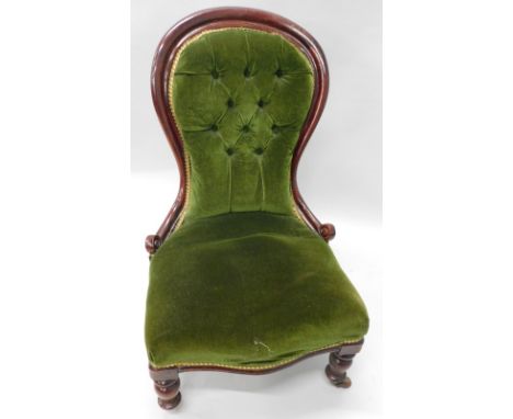 A Victorian mahogany nursing chair, with a padded buttoned back, padded seat, on turned legs, with ceramic castors