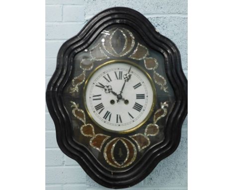 A French ebonised wall clock, the white painted dial with Roman numerals, surrounded by mother of pearl and rosewood inlay, 6