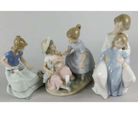 Three Nao porcelain figures, a figure of two children with a baby, a girl with puppies etc.