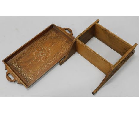 An early 20thC carved oak wall shelf, decorated with squirrels, acorns etc., 35cm wide, and an Indian inlaid tray