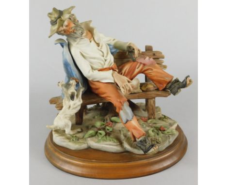 A Capodimonte porcelain figure after Bozzetto, modelled in the form of a tramp on a bench beside a dog, sold with certificate