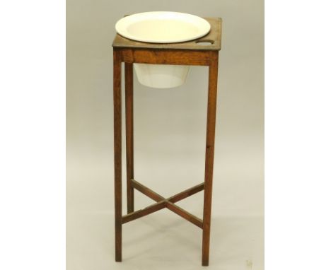 A 19thC oak wash stand, with a later cream glazed ceramic bowl insert, on tapering legs, with 'X' shaped stretcher, 31cm wide