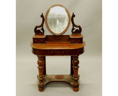 A 19thC mahogany dressing table, the raised back with shaped supports, an oval mirror and two trinket drawers, the bow fronte