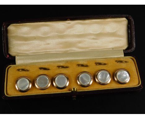 A set of mother of pearl collar studs, on gold plated backs, in a fitted case. 