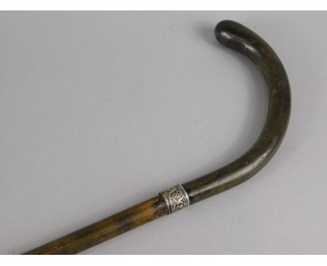 A late 19th/early 20thC walking stick, with unmarked white metal collar and horn handle