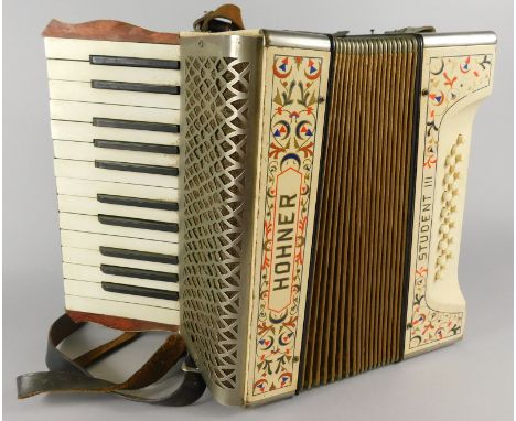 A Hohner Student III piano accordion, with leather strap