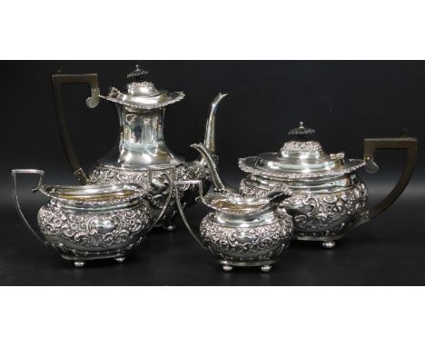 An Edwardian silver four piece tea service, with part fluted and embossed decoration and vacant cartouche, the teapot and cof