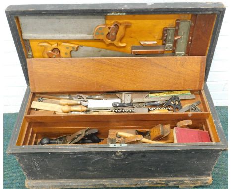 An ebonised pine cabinet maker's tool chest, the interior filled with various tools, to include wooden block planes, Stanley 