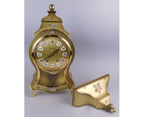 A Swiss Neuchatel type Eluxa mantel clock and bracket, painted with flowers on a gilt ground, sold with some original packagi