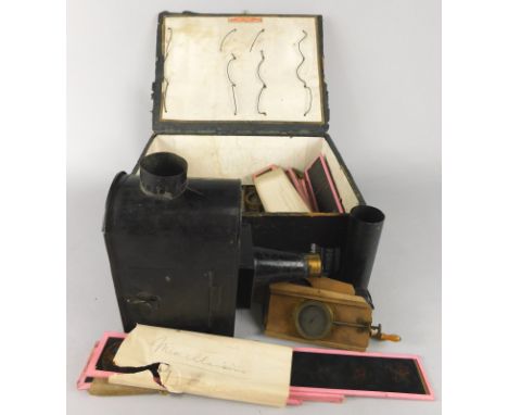 A child's tin plate magic lantern, and various coloured slides etc.