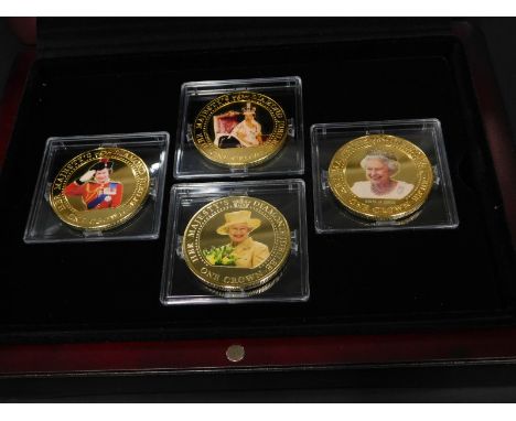 A Queen Elizabeth Diamond Jubilee set of four gilt crowns, inset to each piece with photographic portrait, in a fitted case