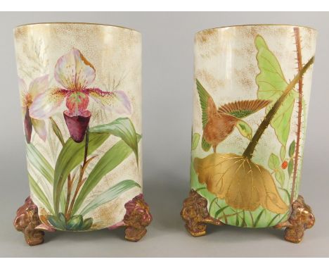 A pair of Staffordshire ceramic vases, each decorated with birds, flowers, berries, leaves etc., on gilt lion mask feet, 25cm