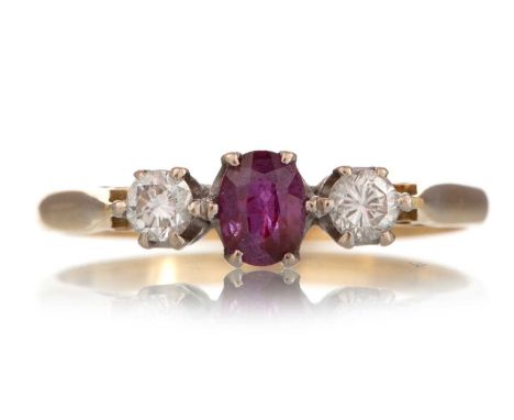 RUBY AND DIAMOND RING set with oval ruby flanked by small diamonds, in eighteen carat gold, size R 1/2Qty: 2.6g