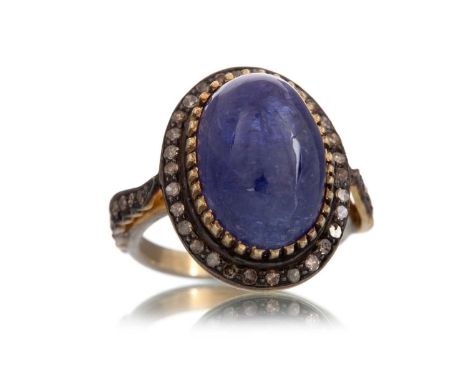 TANZANITE AND DIAMOND RING, set with an oval cabochon tanzanite of approximately 7.20 carats, within a diamond halo, on diamo