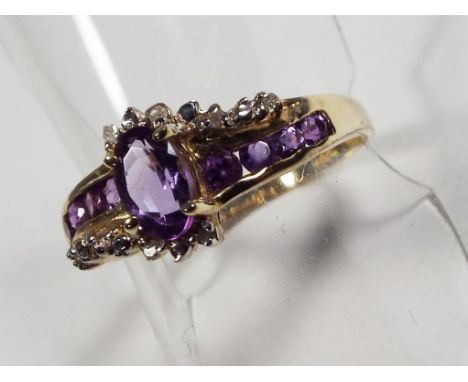 A lady's yellow metal dress ring stamped 375 9K set with lab created amethyst, size O, approx 1.55 gm (all in), cased - Est £