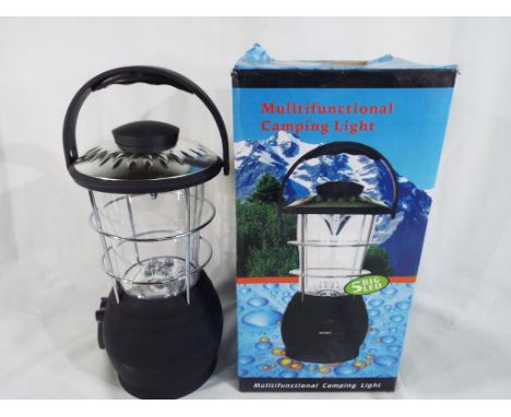 A multi functional wind-up camping lamp, new, boxed