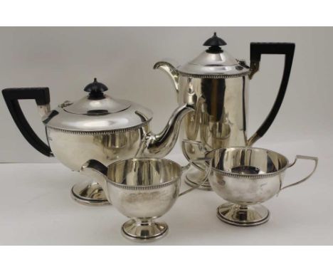 WALKER &amp; HALL AN ART DECO FOUR PIECE SILVER TEASET, comprising; teapot, hot water pot, milk jug, sugar bowl, each with eg