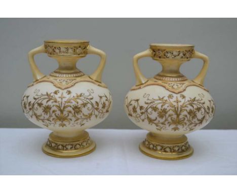 A PAIR OF APRICOT BLUSH GROUND ROYAL WORCESTER GLOBULAR BODIED VASES, overlaid with gilt floral fronds, each having twin hand