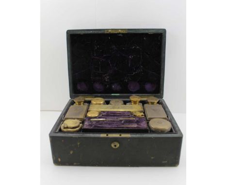 THOMAS DILLER A MID-19TH CENTURY LEATHER CASED TRAVELLING SET, containing twelve cut glass items with silver gilt covers, inc