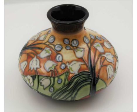 A MOORCROFT CERAMIC VASE of squat form, tube lined and painted with lily-of-the-valley decoration, various impressed and pain