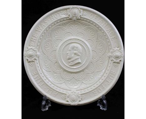 A "MINTONS" SALT GLAZED EARTHENWARE WALL CHARGER moulded with a portrait of William Shakespeare, with the motto "He was not o
