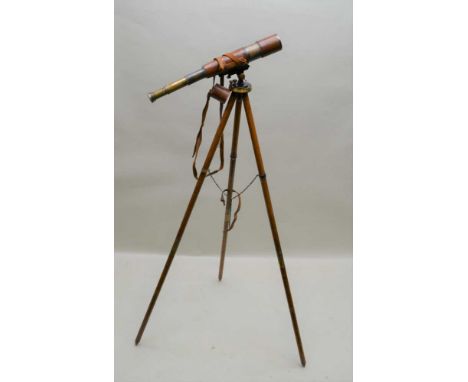 AN EARLY 20TH CENTURY FOUR DRAW BRASS TELESCOPE in leather cover with shoulder strap, together with a folding polished wood M