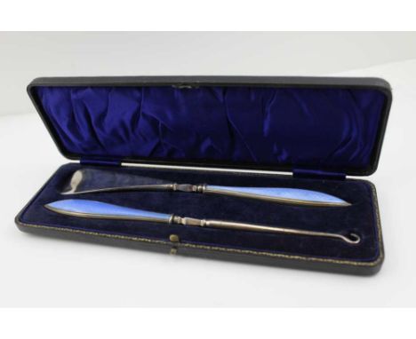 A CASED SHOE HORN AND BUTTON HOOK, silver handles with pale blue guilloche enamel panels inset, Birmingham 1929 