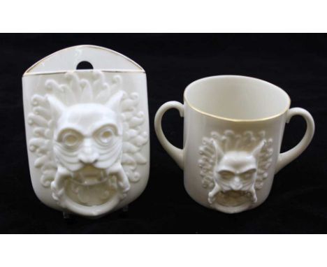 A W.H. GOSS FLOWER HOLDER, moulded with the Durham Abbey knocker, together with a W.H. Goss TWO-HANDLED MUG, modelled with th