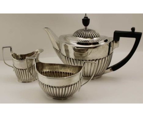 GOLDSMITHS &amp; SILVERSMITHS COMPANY (William Gibson and John Lawrence Langman) A VICTORIAN SILVER THREE PIECE TEA SET of fl