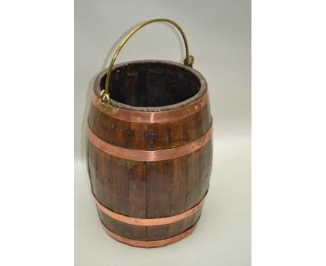 A LATE 19TH CENTURY COOPERED BARREL STICK STAND, with brass swing handle and copper coloured banding, 44cm high 