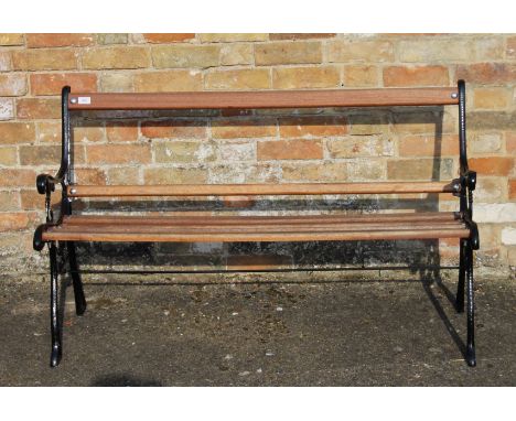 A wooden slatted garden bench. 125 cm long.