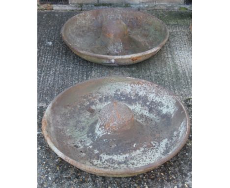 Two small Mexican hat cast iron pig feeders. 70 cm diameter. 