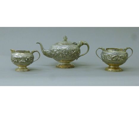 An early 20th century Indian unmarked white metal three-piece tea set, the cream jug and sugar bowl marked 'Calcutta August 2