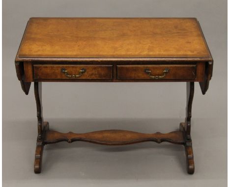 A Maple walnut miniature sofa table. 68 cm wide flaps down x 51.5 cm high.