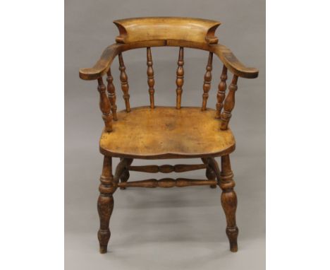 A Victorian smoker's bow armchair. 68.5 cm wide.