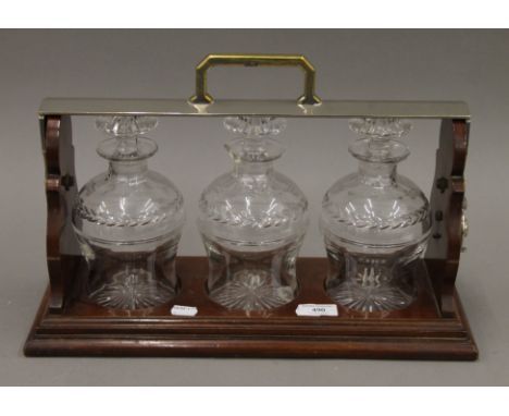 A three-bottle tantalus. 40 cm long.