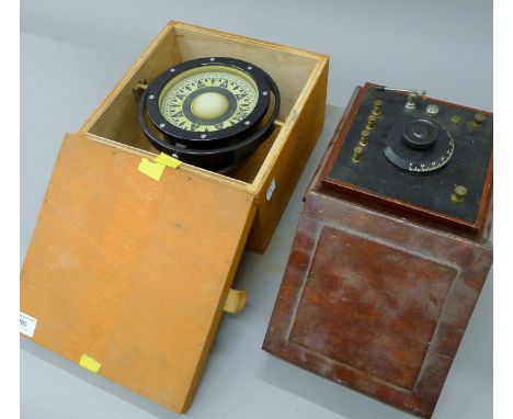 A boxed Gimbal mounted compass and another boxed instrument. The former 24 cm wide.