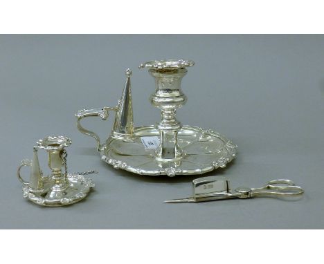 A Georgian silver chamber stick with snuffer and associated wick trimmer/snuffer together with a small Victorian taper stick 