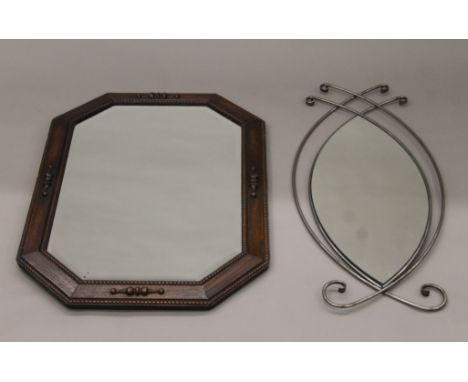 An early 20th century oak-framed bevelled mirror and a contemporary metal-framed mirror. The former 87 x 60 cm.