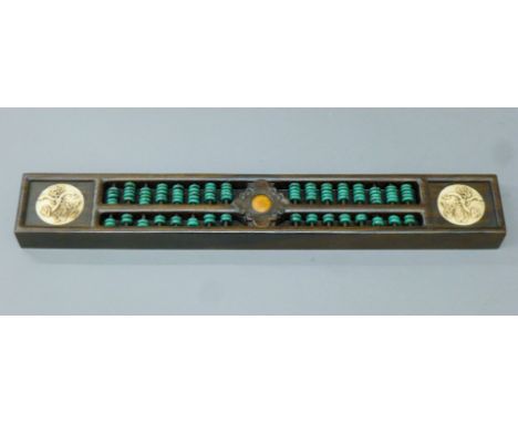 A Chinese abacus. 38 cm long.