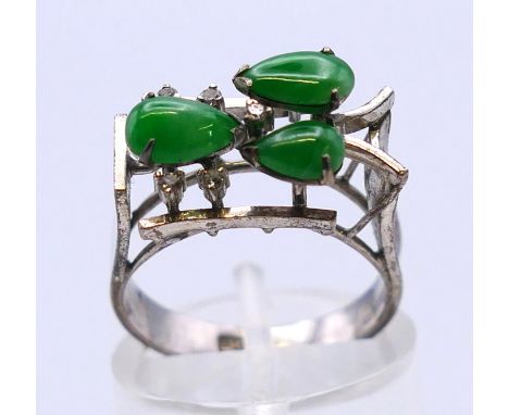 A Chinese white gold, diamond and jade ring. Ring size K/L. 3.3 grammes total weight.
