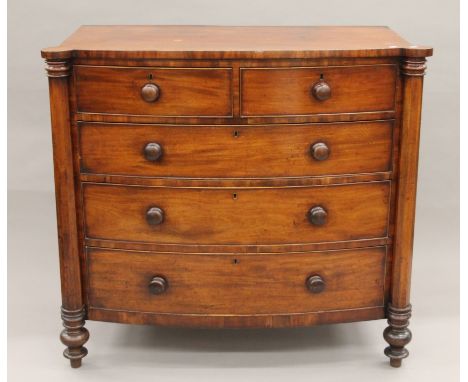 A Georgian mahogany bow-front two-over-three chest of drawers. 124 cm wide x 114 cm high.