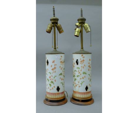 A pair of 19th century Chinese pierced porcelain lamps. Each 62 cm high.