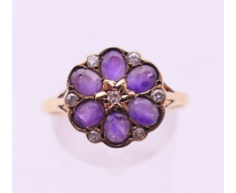 A 9 ct gold, amethyst and diamond cluster ring. Ring size U.  