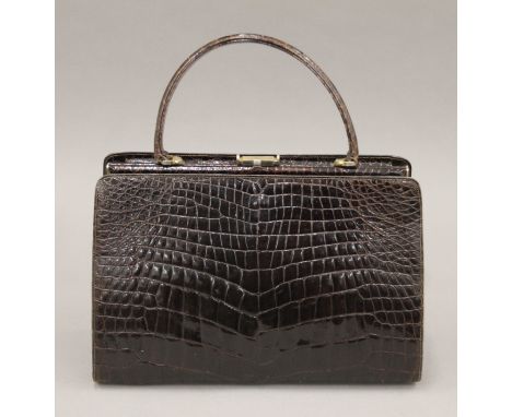 A vintage crocodile skin handbag. 31 cm wide.