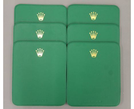 Six Rolex place mats. 24 x 20 cm.
