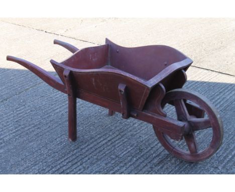 A vintage painted wheelbarrow. 180 cm long x 64 cm wide.