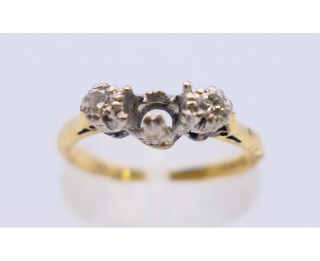 An 18ct gold and diamond ring (lacking centre stone). Ring size K/L. 2.7 grammes total weight.